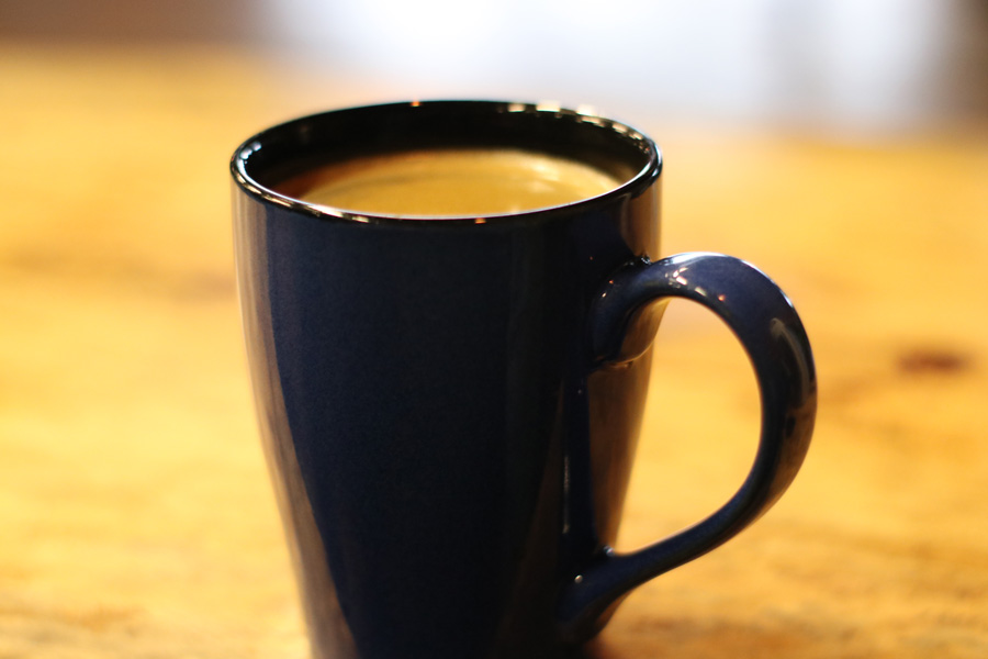 Cup of coffee sitting on a table in a cafe.